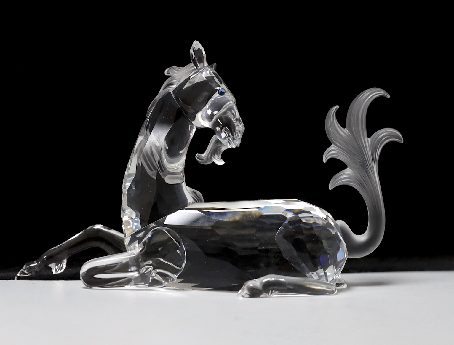 Three Swarovski Crystal figures comprising Pegasus, unicorn and dragon, each with boxes and booklets, the largest 15cm wide